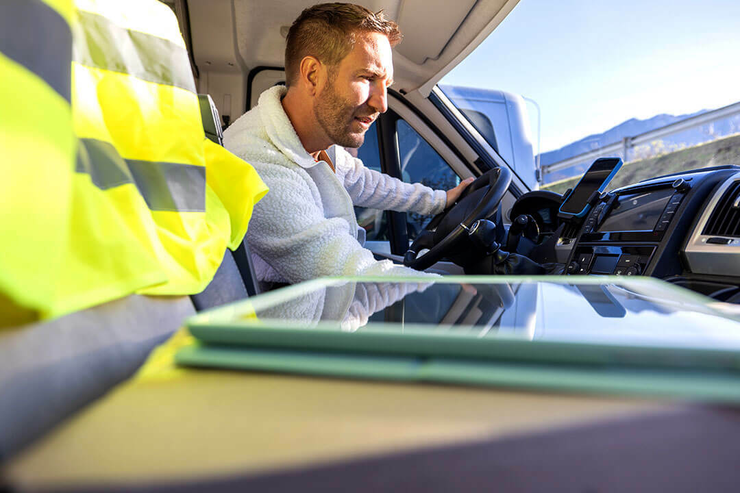 Worker looking at phone in service van