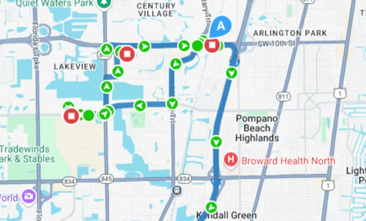 A digital map showing a blue route path with various green and red circular markers highlighting transit stops or points of interest in the Pompano Beach area.