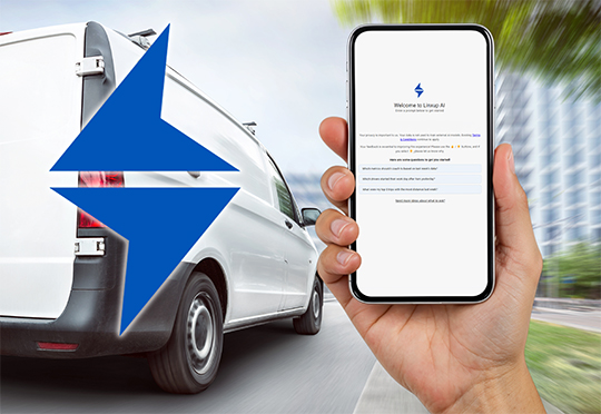 A hand holds a smartphone displaying a mobile app interface against a blurred background of a white delivery van driving on a street.