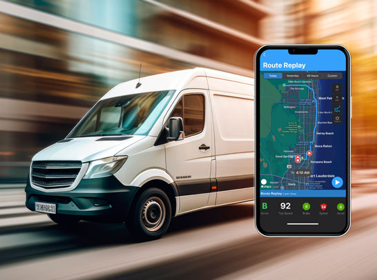 A white delivery van drives through a motion-blurred city street, next to a smartphone displaying a route replay map and trip analytics.