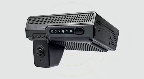Compact black dash cam with a built-in camera, ventilation holes, and control buttons on the side.