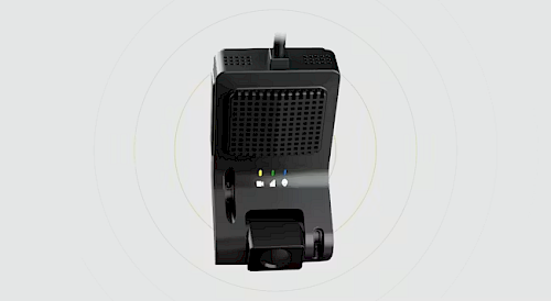 A top-down view of a black electronic device with a grid-patterned speaker area and indicator lights; it has a small camera or microphone attachment at the base, mounted on a swivel stand.