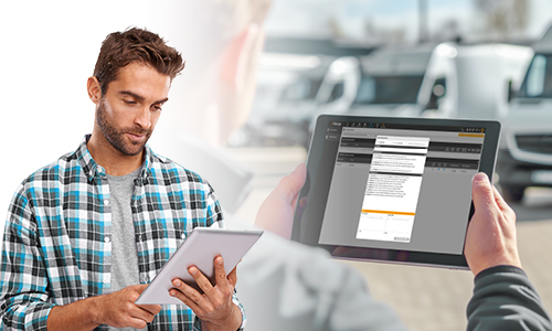 A laptop and a smartphone displaying the same fleet management software dashboard, which features data charts, tables, and a map-based tracking interface.